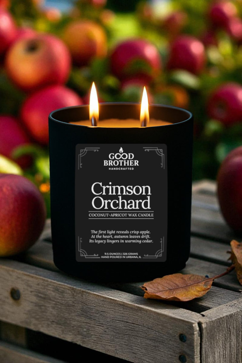 Candle labeled 'Crimson Orchard' by Good Brother with apples in the background