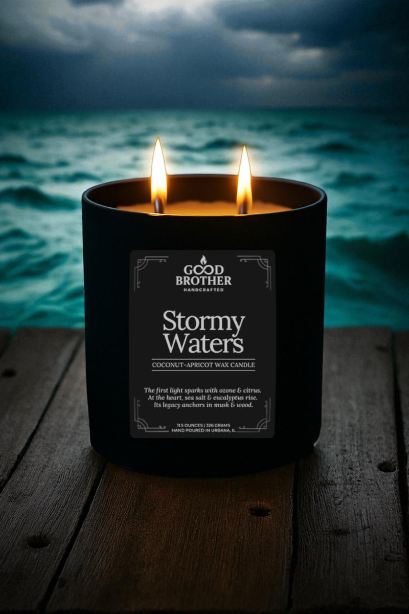 Candle labeled 'Stormy Waters' by Good Brother with stormy ocean view in the background.